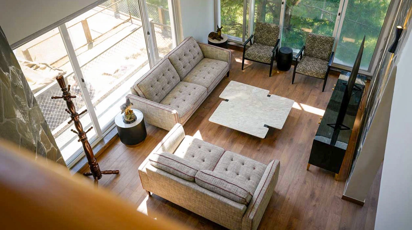 Scenic stone villa surrounded by pine forests at sunset — best second home investment in Pakistan in Galiyat mountains